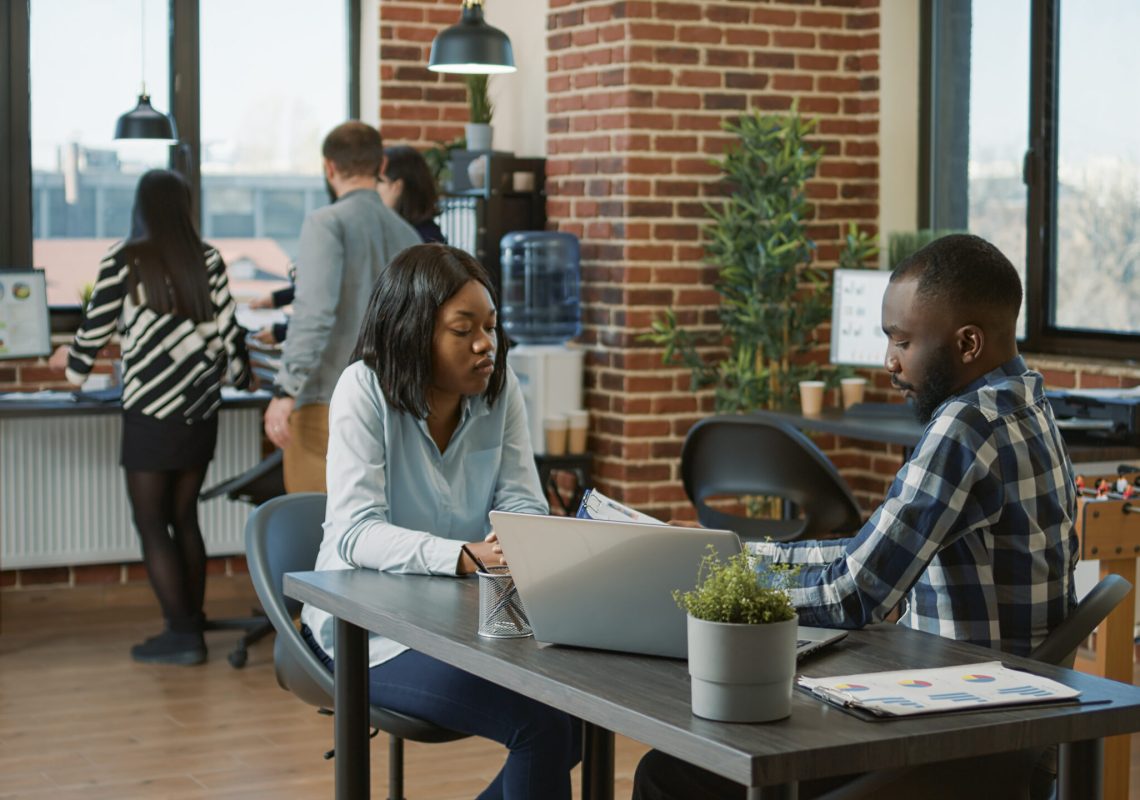 African american people greeting at job interview appointment, talking about HR recruitment and work application. Man and woman meeting to talk about executive career opportunity.