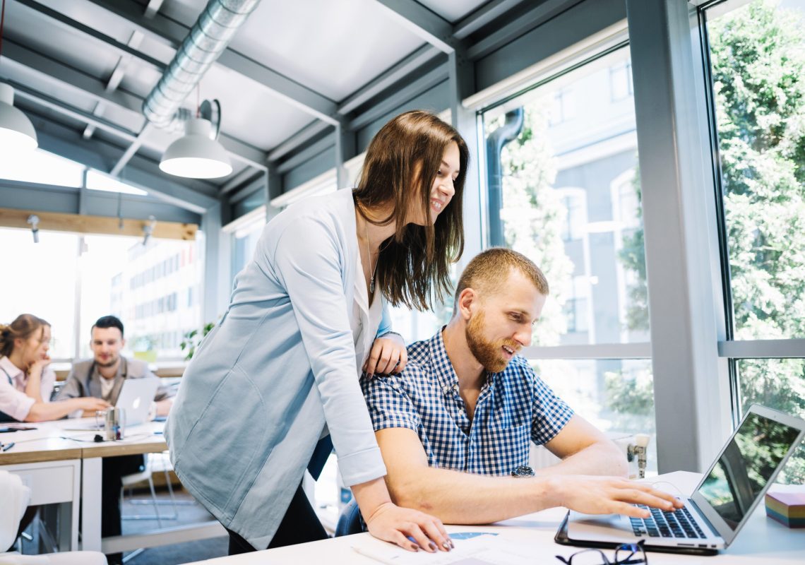 smiling-man-woman-cooperating-laptop (1)